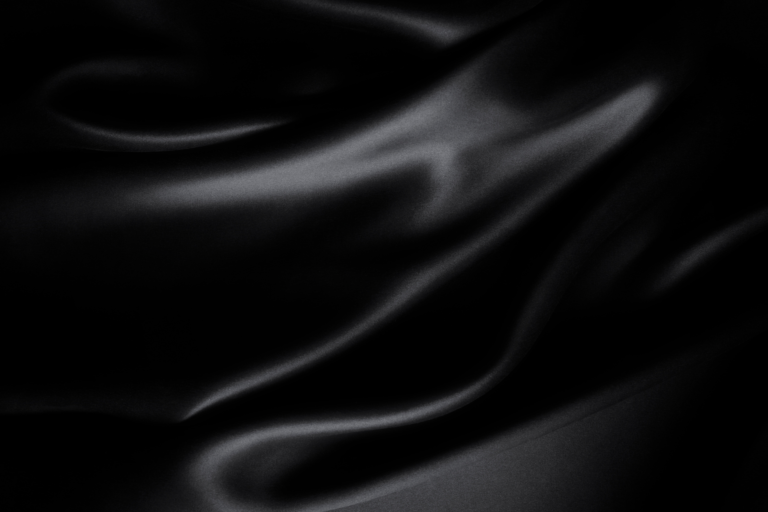 Satin black silk background, close-up
